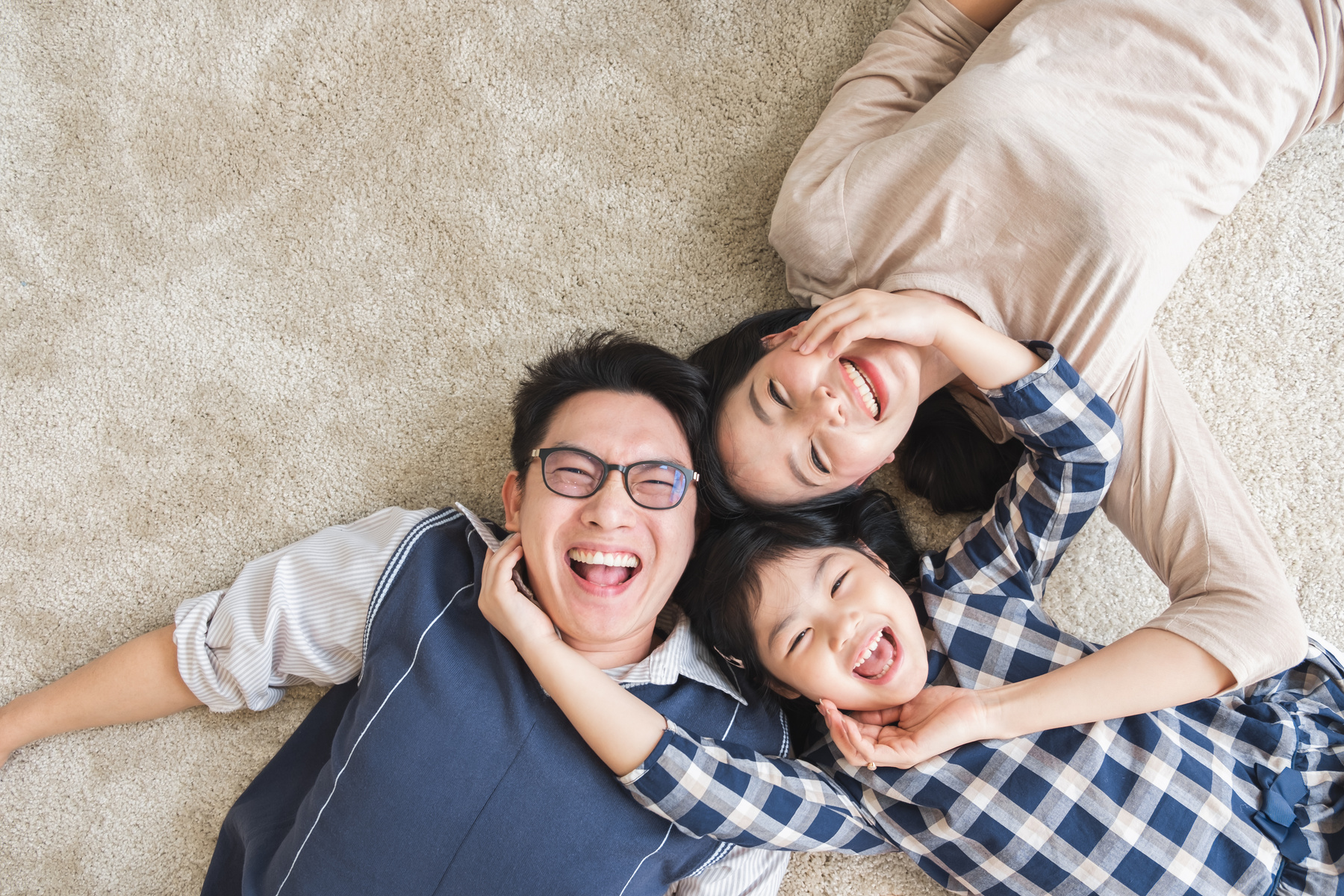 Happy Asian family laying with happy and smile, top view
